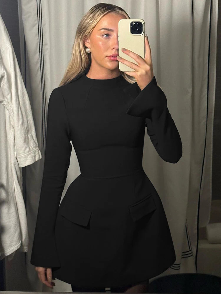 Long-sleeve bodycon mini dress with zipper and pockets.