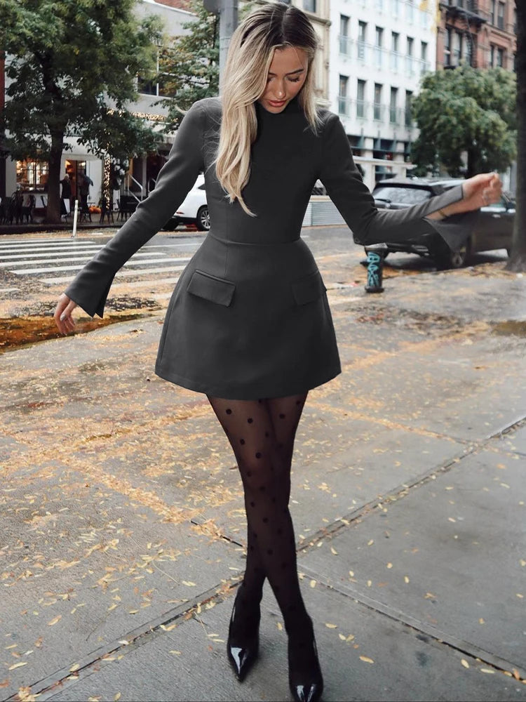 Long-sleeve bodycon mini dress with zipper and pockets.