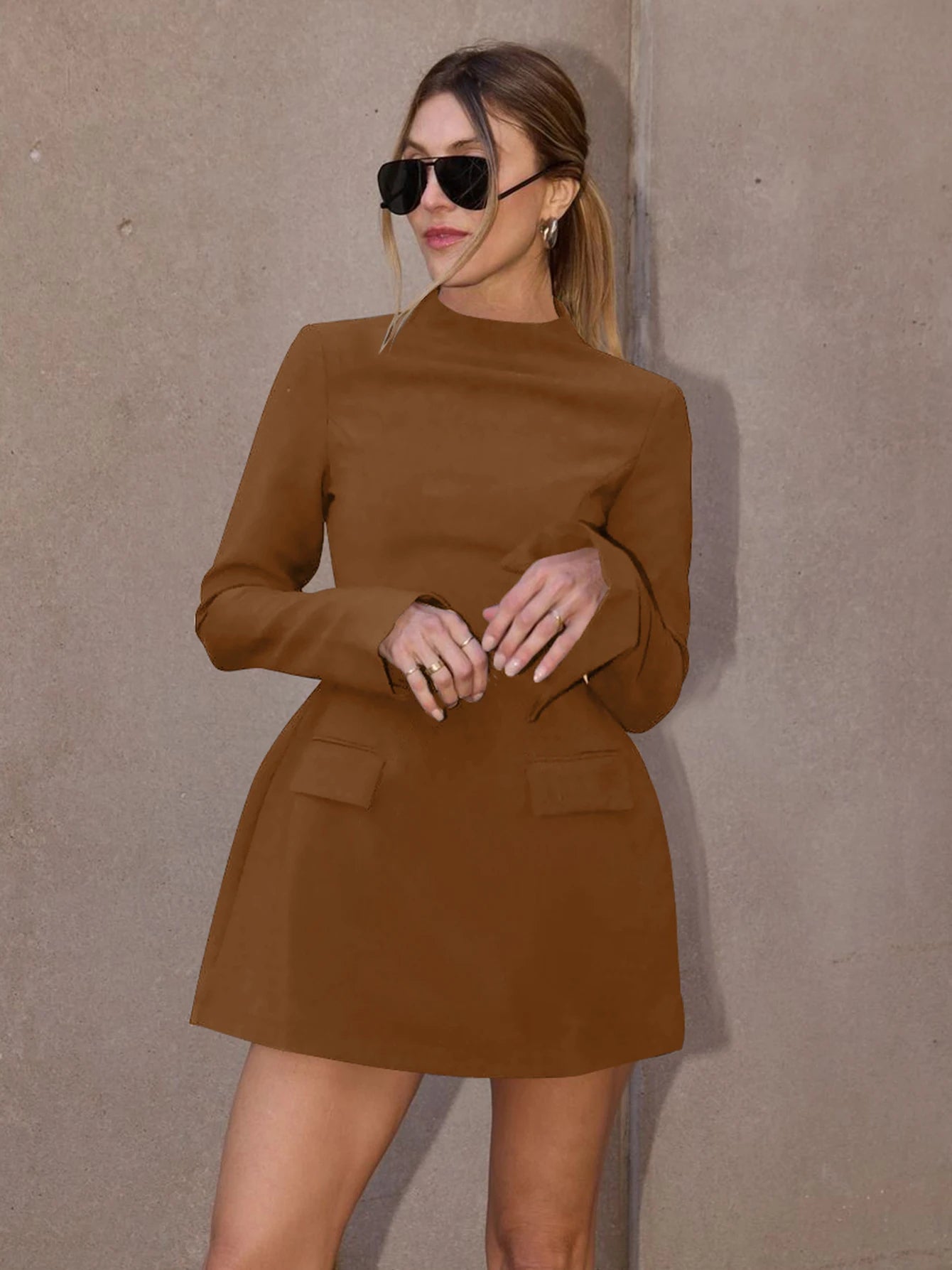 Long-sleeve bodycon mini dress with zipper and pockets.